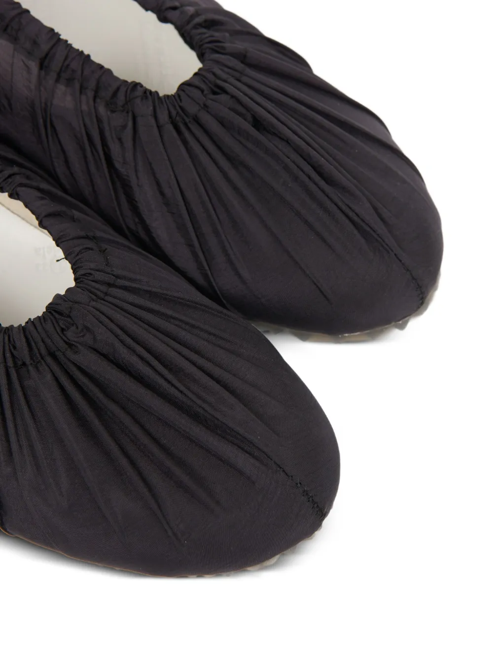 close up of black sneakers, showing texture of the  cotton fabric