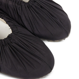 close up of black sneakers, showing texture of the  cotton fabric