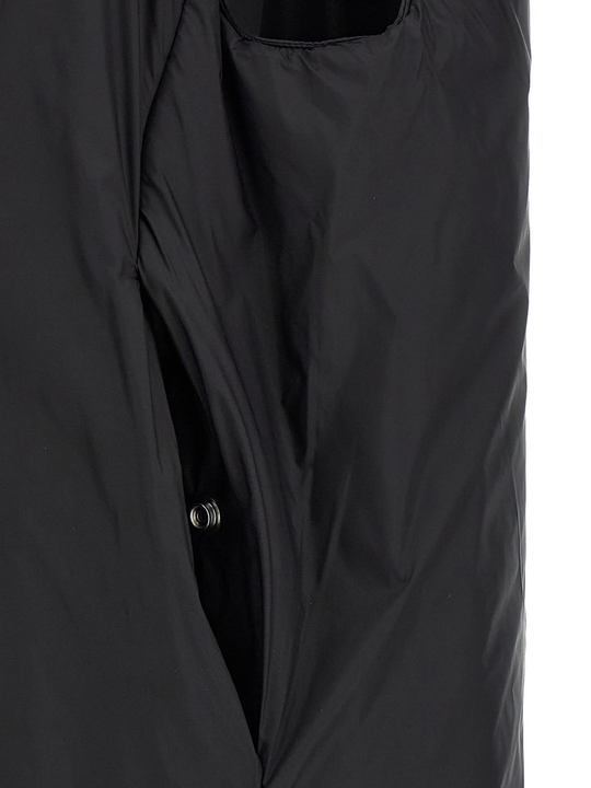 Black coat  worn by a person, showing the coat's fit