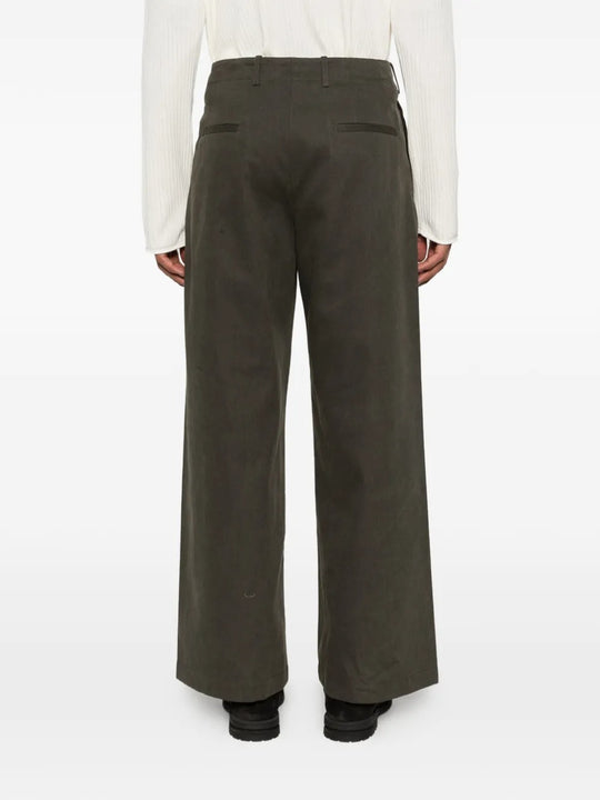 Green pants worn by a person, showing the pants's fit