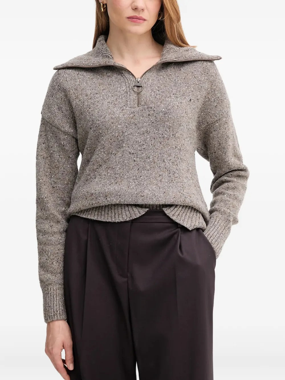 Grey knitwear worn by a person, showing the knitwear's fit