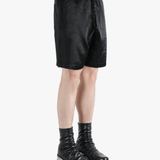 black pants worn by a person, showing the pants fit