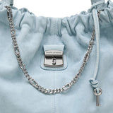 Close up of blue bags, showing texture of the suede cow leather fabric