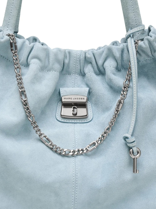 Close up of blue bags, showing texture of the suede cow leather fabric