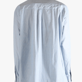 Blue shirt worn by a person, showing the shirt's fit