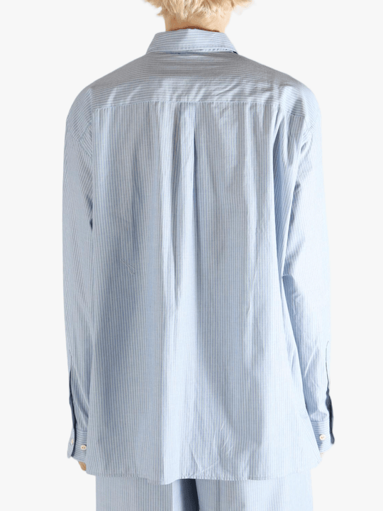 Blue shirt worn by a person, showing the shirt's fit