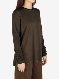 Brown top worn by a person, showing the top's fit
