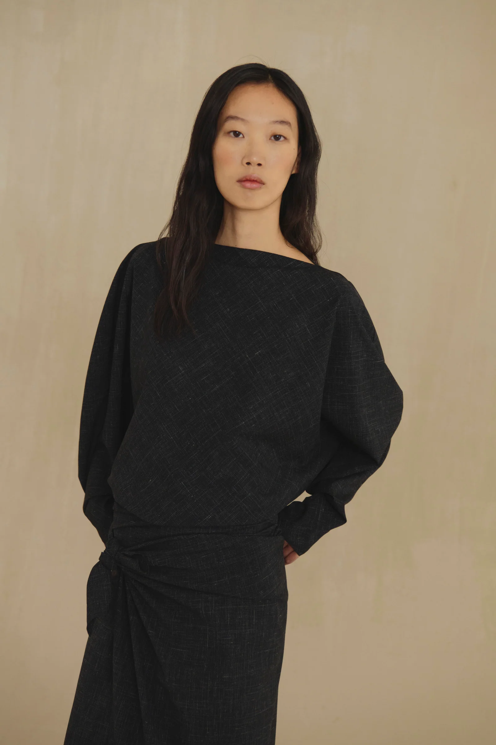 Black top worn by a person, showing the top fit