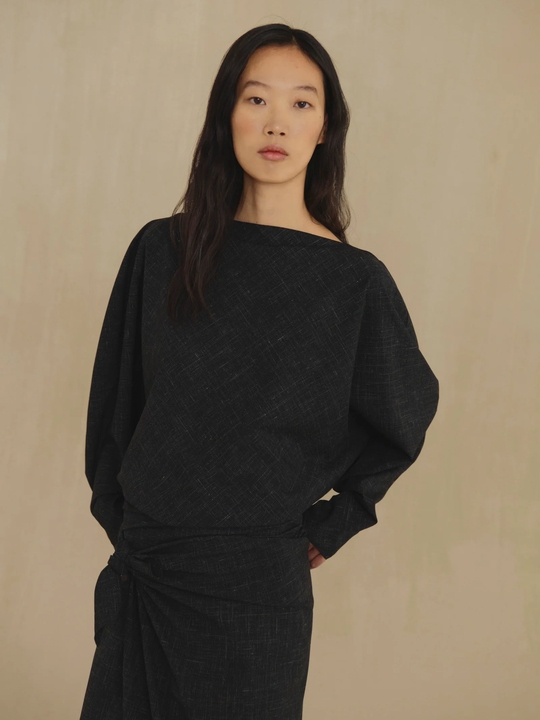 Black top worn by a person, showing the top fit