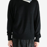 Black top worn by a person, showing the top's fit