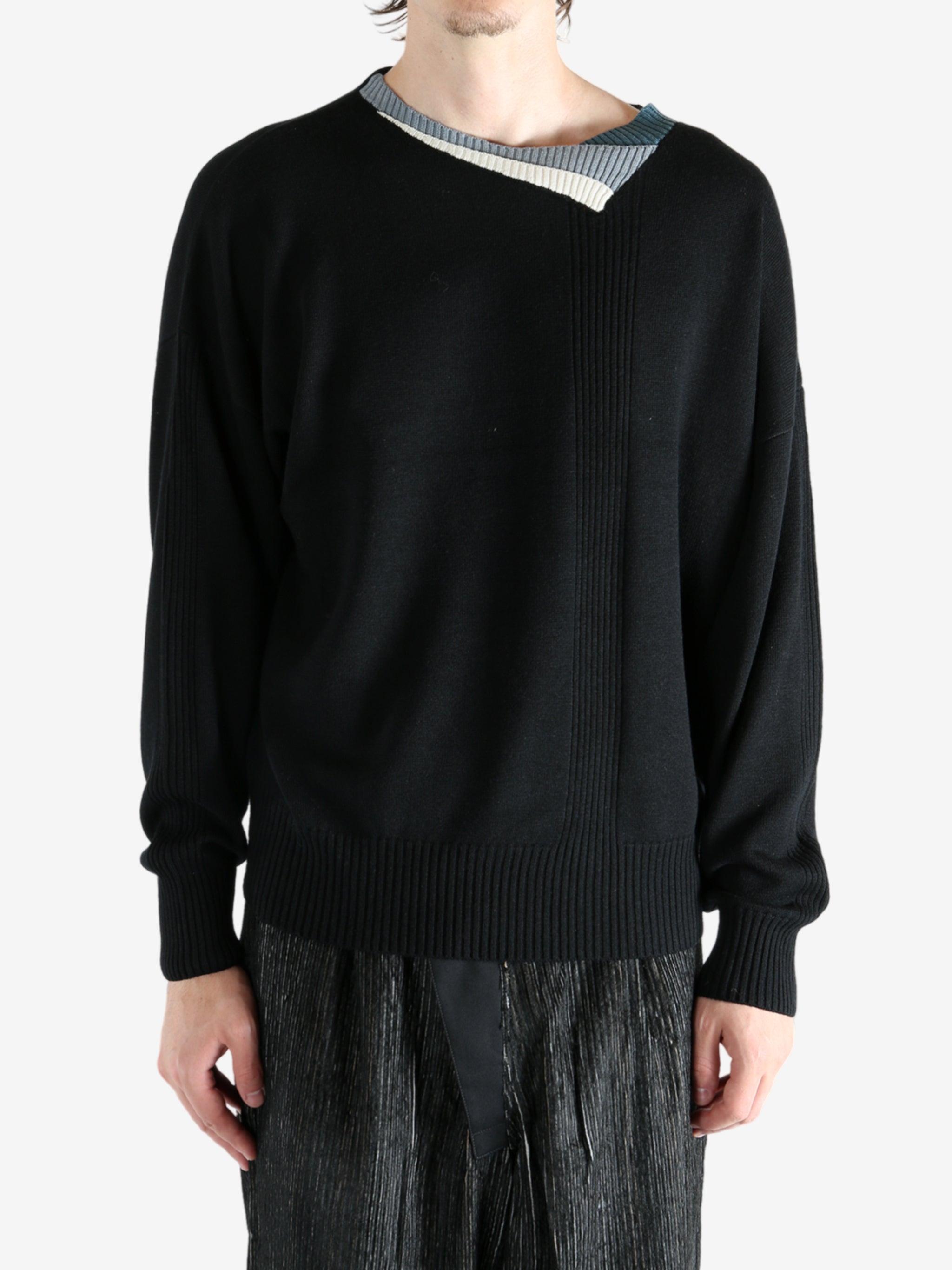 Black top worn by a person, showing the top's fit