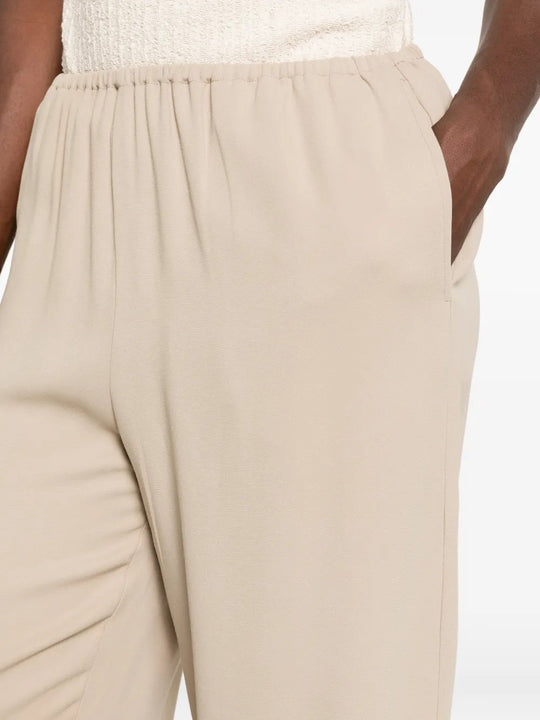 Tan pants worn by a person, showing the pants fit