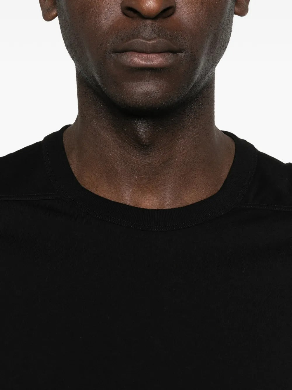 Close up of black t-shirts, showing texture of the cotton fabric