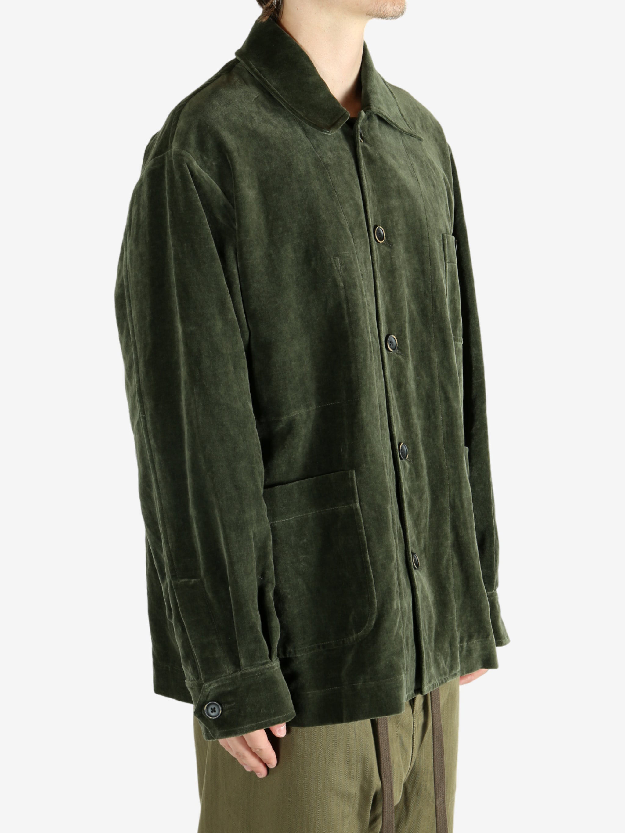 Green jacket worn by a person, showing the jacket's fit