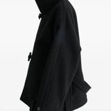 Black coat worn by a person, showing the coat's fit
