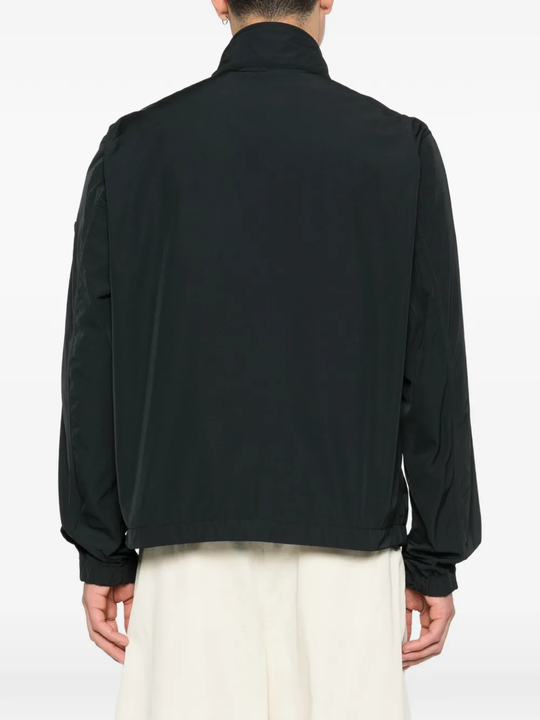 Black jacket worn by a person, showing the jacket fit