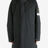 Black coat worn by a person, showing the coat fit