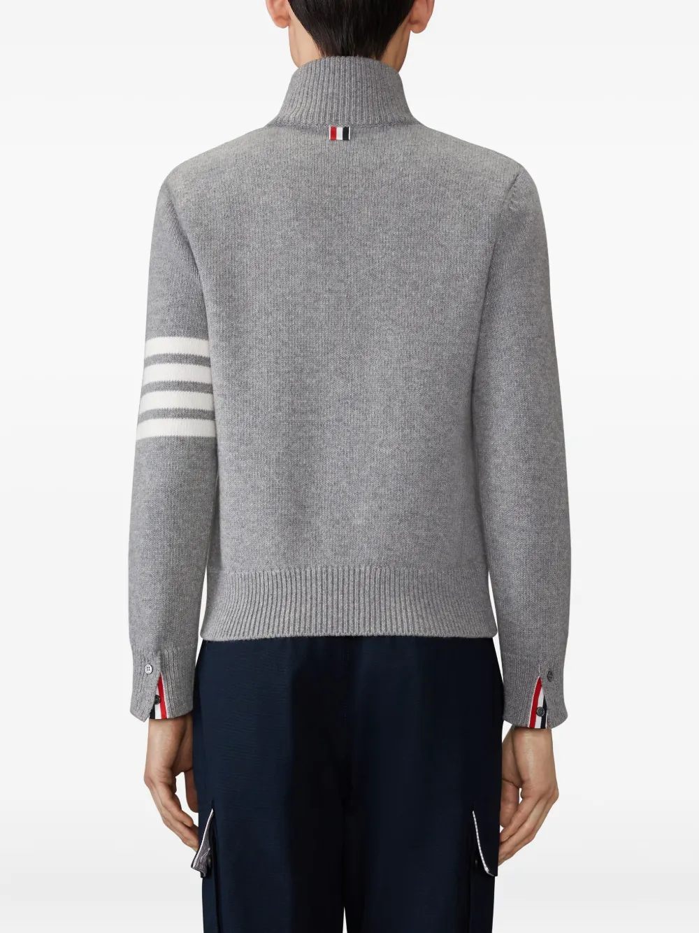 grey knitwear worn by a person, showing the knitwear fit