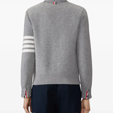 grey knitwear worn by a person, showing the knitwear fit