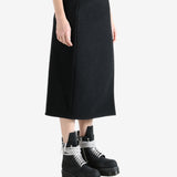 Black skirts worn by a person, showing the skirts fit