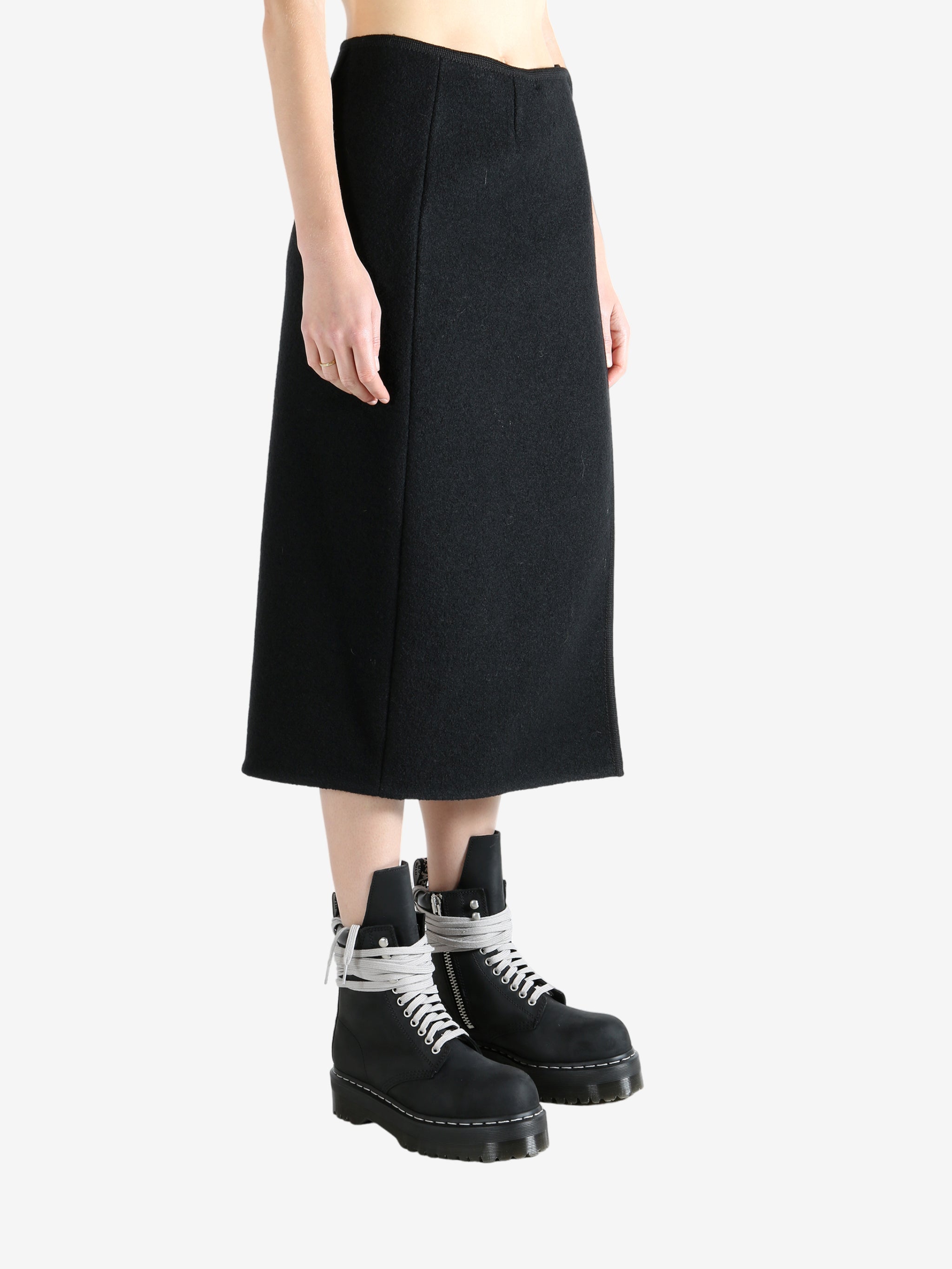 Black skirts worn by a person, showing the skirts fit