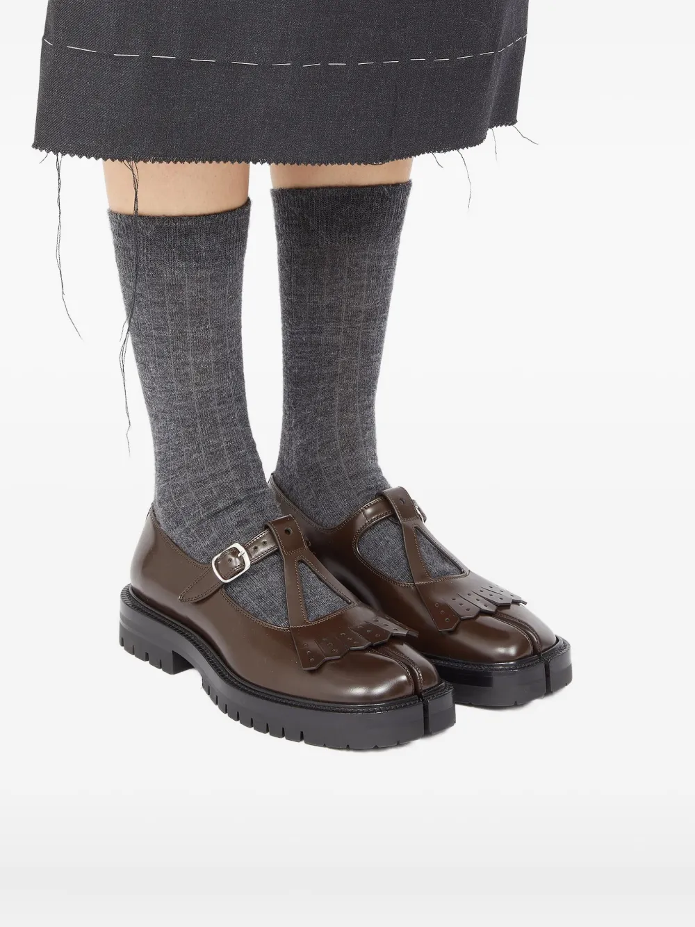 Brown shoes worn by a person, showing the shoes's fit