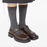 Brown shoes worn by a person, showing the shoes's fit