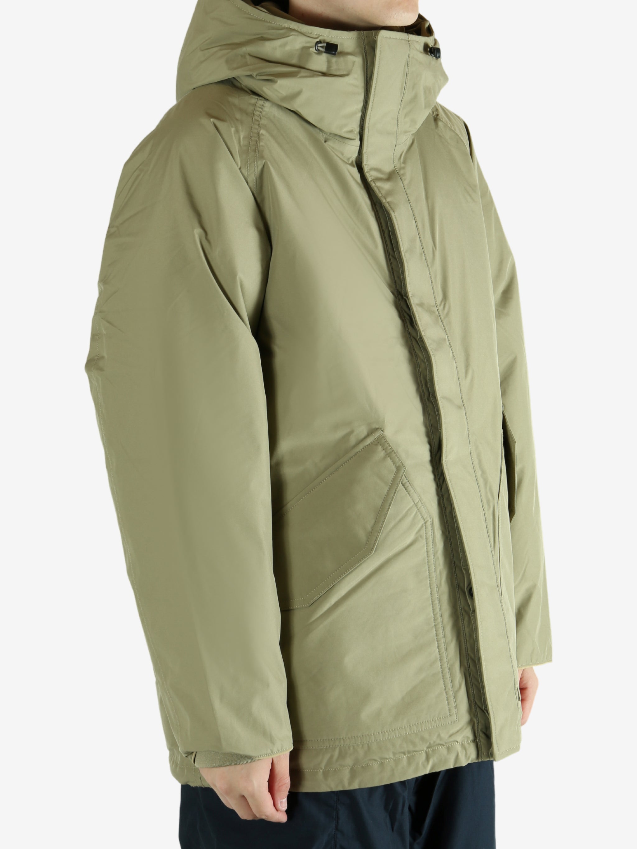 Green jacket worn by a person, showing the jacket's fit