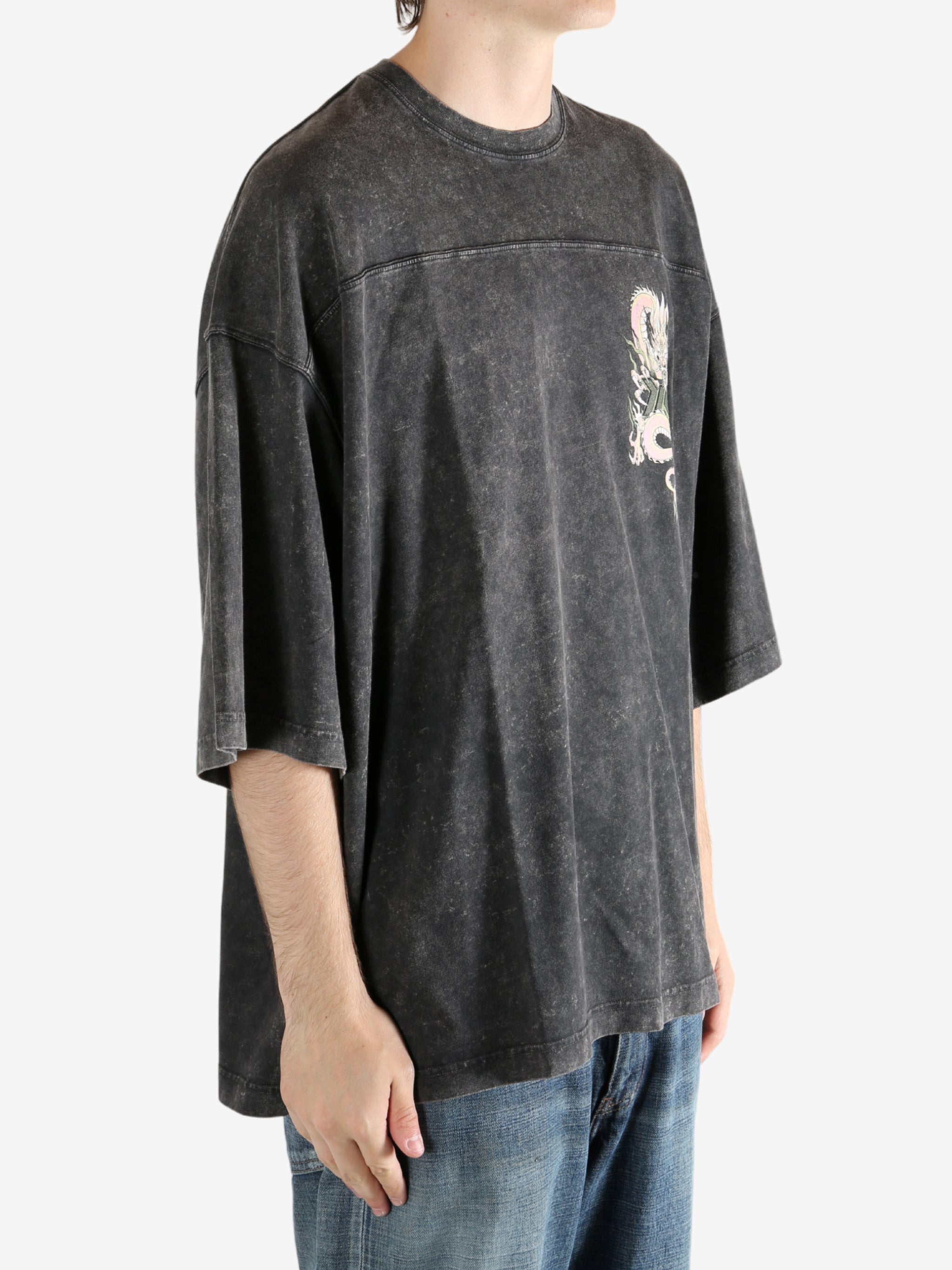 Black t-shirt worn by a person, showing the t-shirt's fit