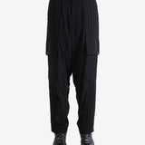 Black pants worn by a person, showing the pants' fit