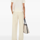 Tan top worn by a person, showing the top's fit