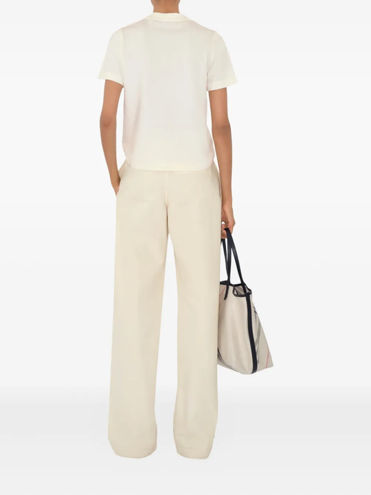 Tan top worn by a person, showing the top's fit