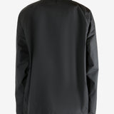 Black jacket worn by a person, showing the jacket's fit