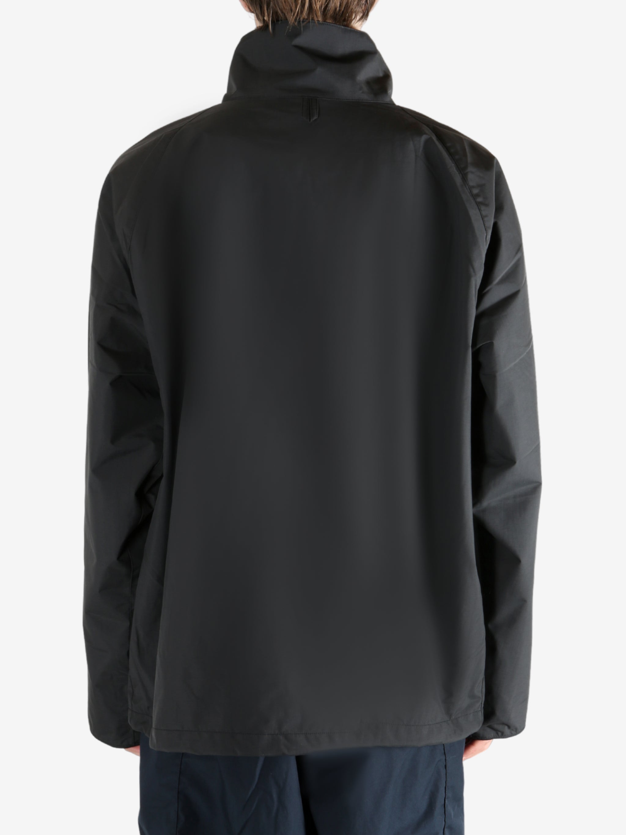 Black jacket worn by a person, showing the jacket's fit