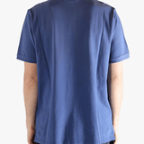 Blue polo shirt worn by a person, showing the shirt's fit