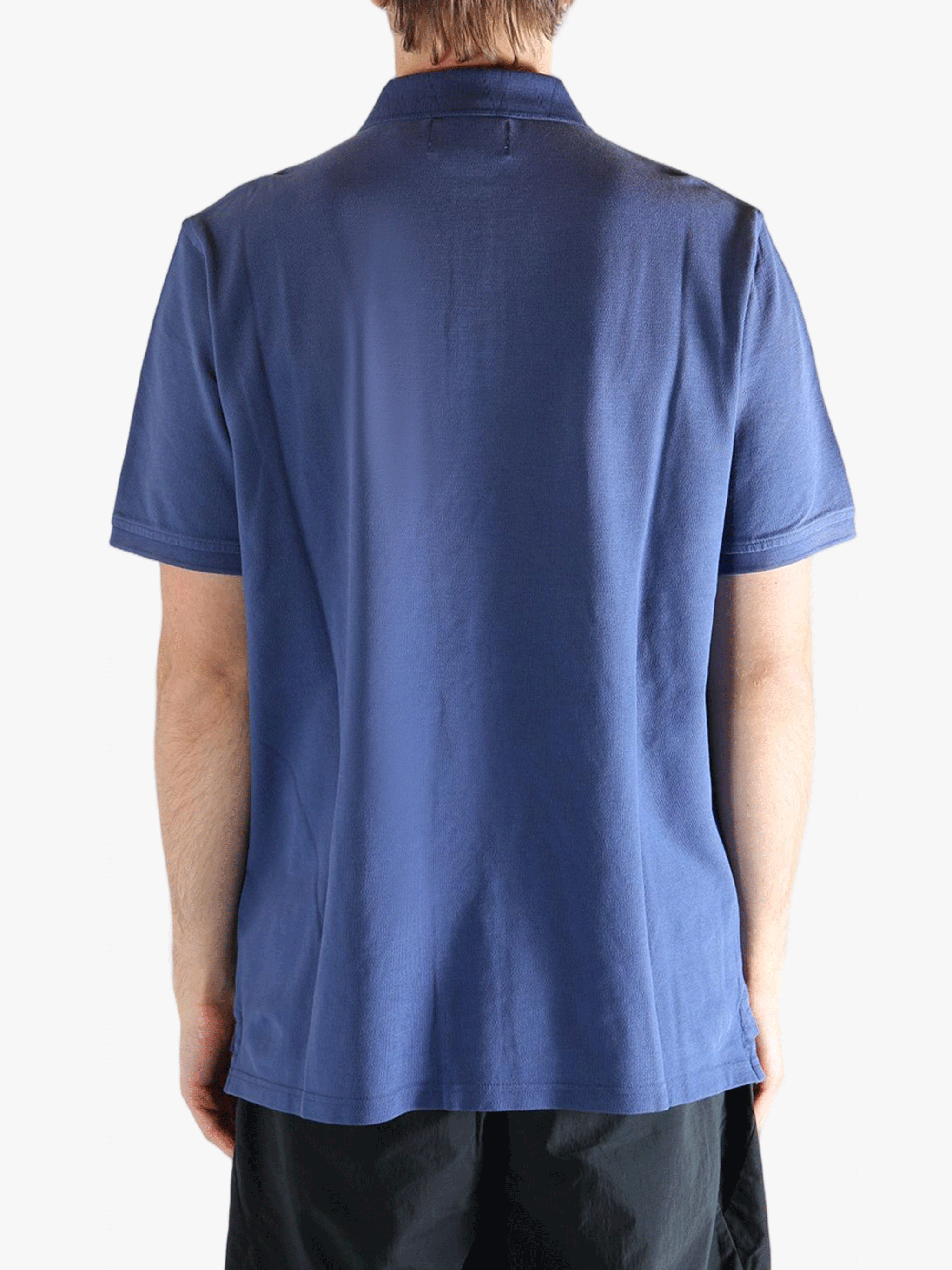 Blue polo shirt worn by a person, showing the shirt's fit