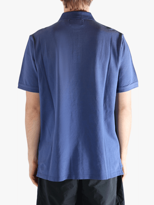 Blue polo shirt worn by a person, showing the shirt's fit