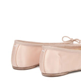 Close up of pink shoes, showing texture of the fabric