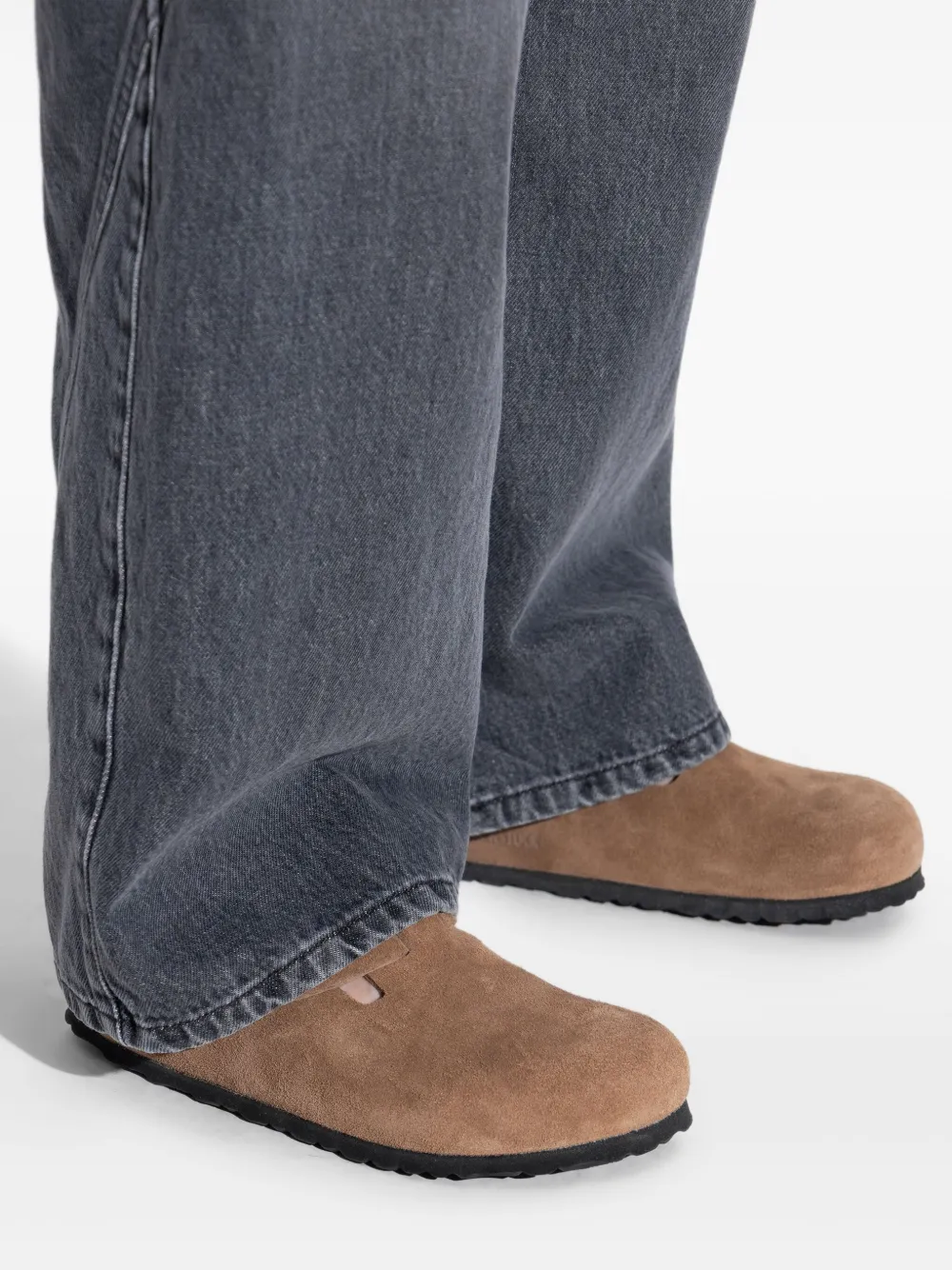 Brown sandals worn by a person, showing the sandal's fit