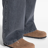 Brown sandals worn by a person, showing the sandal's fit