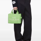 Green bags worn by a person, showing the bags fit