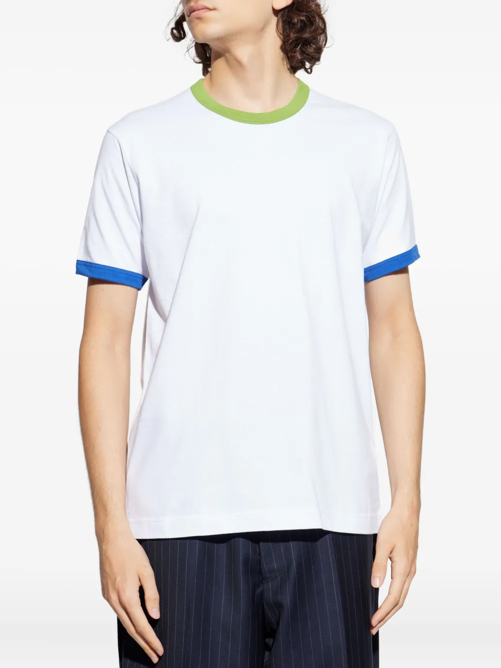 White t-shirt worn by a person, showing the shirt's fit