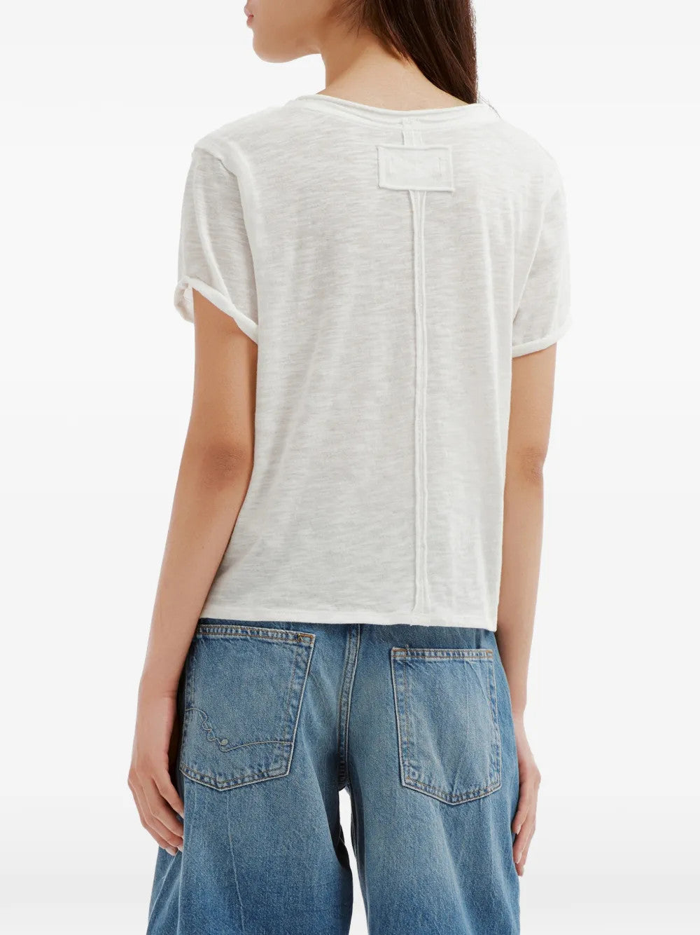 White t-shirt worn by a person, showing the t-shirt fit