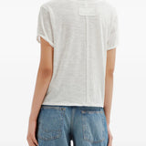 White t-shirt worn by a person, showing the t-shirt fit