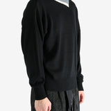 Black top worn by a person, showing the top's fit