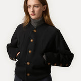 Black jacket worn by a person, showing the jacket fit