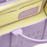 Close up of purple bag, showing texture of the leather fabric