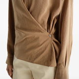 Tan dress worn by a person, showing the dress fit