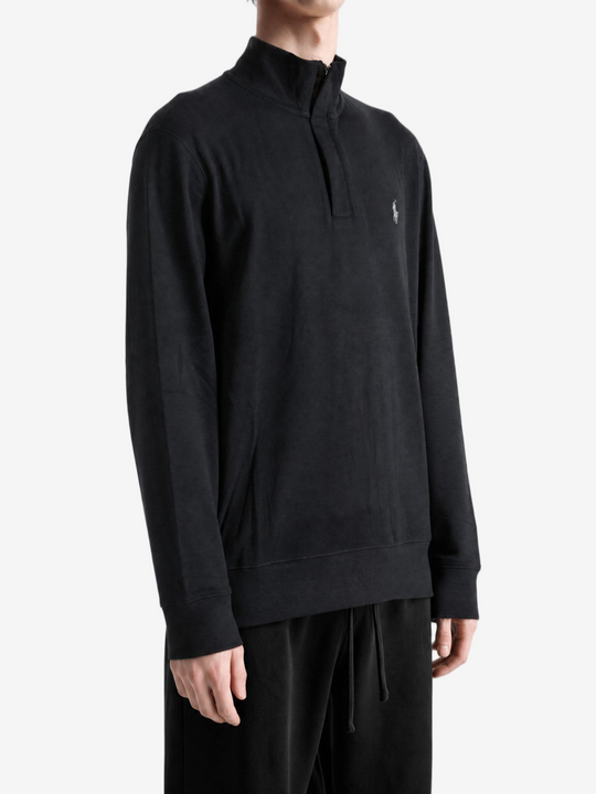 Black knitwear worn by a person, showing the knitwear fit