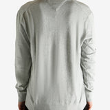 Grey sweater worn by a person, showing the sweater's fit